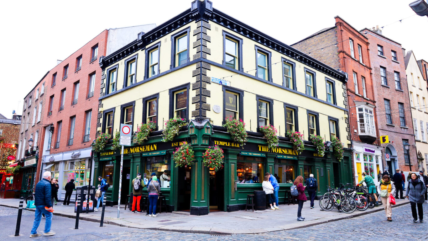 A street corner with a yellow and green pub named 